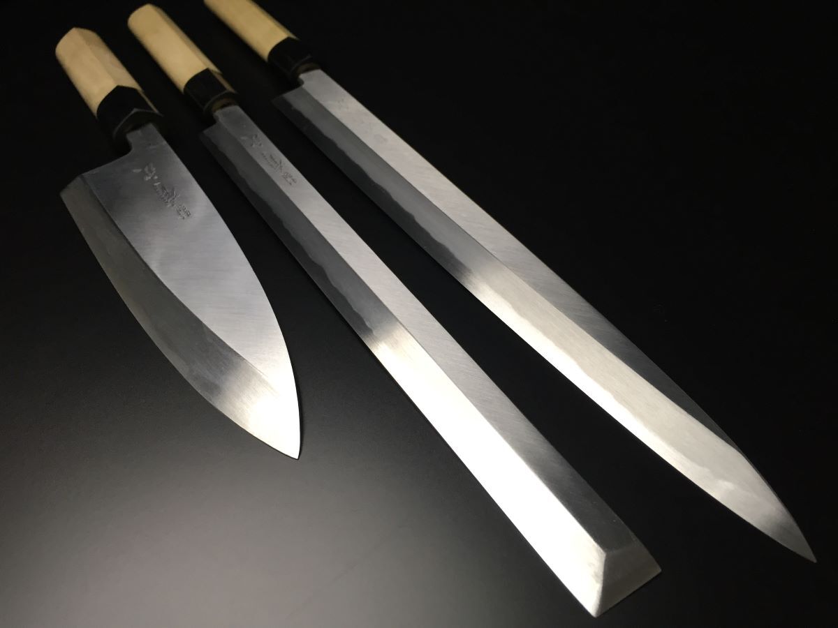 Authentic Aritsugu Japanese chef knives with a high-carbon steel blade for professional culinary use.